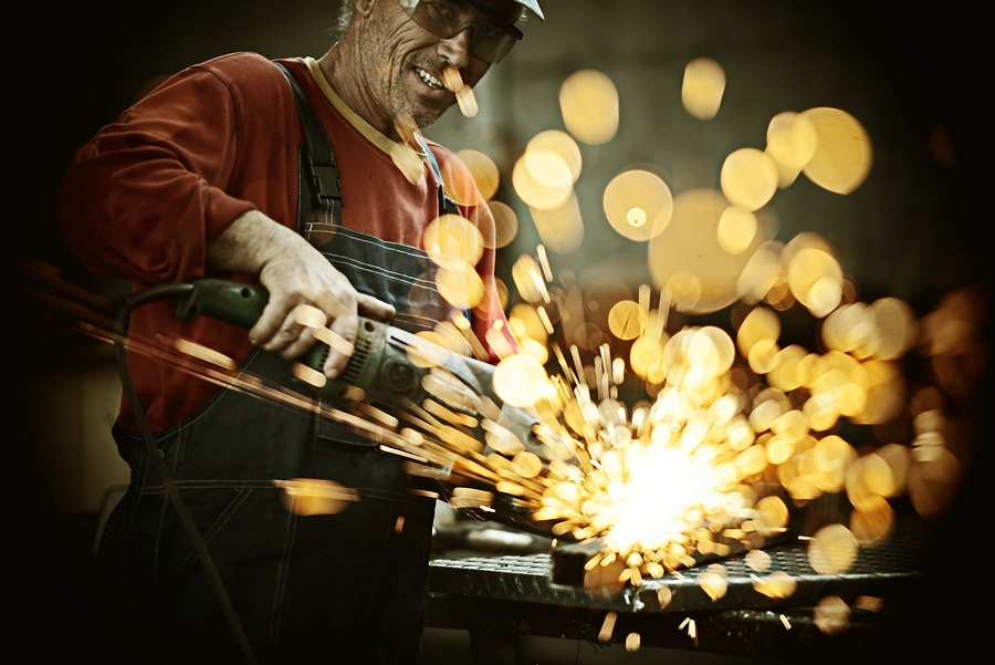 bigstock-Industrial-worker-cutting-and--60899459